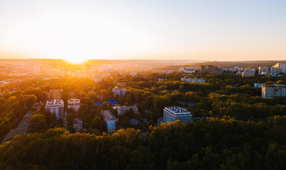 Aerial drone photo of beautiful green city at sunset