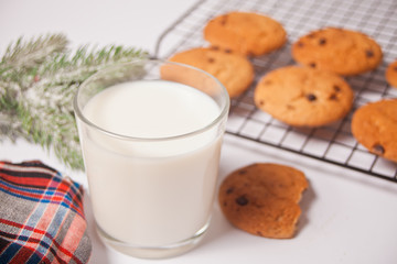 Obraz na płótnie Canvas Glass of milk, homemade cookies for Santa on the white background