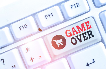 Text sign showing Game Over. Business photo text A situation in a particular sport that reach his finals or ending White pc keyboard with empty note paper above white background key copy space