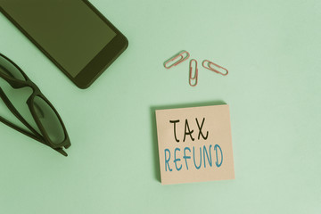 Conceptual hand writing showing Tax Refund. Concept meaning applied when money liability is less...