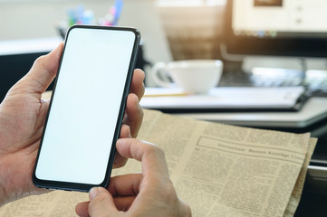Closeup man using smartphone at  office. Blank screen for graphics display montage.