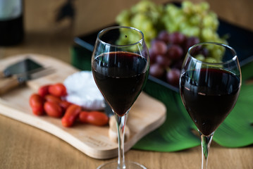 Waiter pouring red wine into wineglass. 