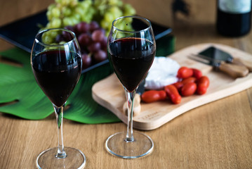 Waiter pouring red wine into wineglass. 