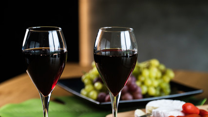 Waiter pouring red wine into wineglass. 