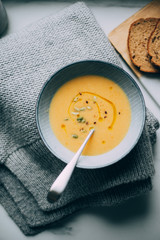 Pumpkin soup with ingredients on marble background table