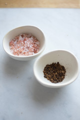 Himalayan salt and pepper on a marble background