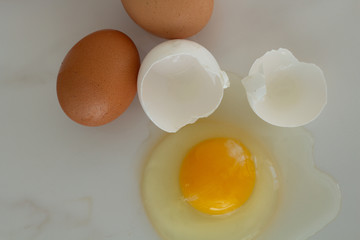 eggs and broken egg on white background close-up