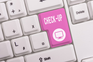 Text sign showing Check Up. Business photo text physical medical or clinical examination made by examinings White pc keyboard with empty note paper above white background key copy space
