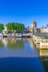 Obraz na płótnie Canvas Paris, the Pont des Arts on the Seine, and the Institut de France, beautiful monument 