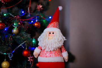 Christmas tree with garlands, vintage toys and decorative fireplace in studio.