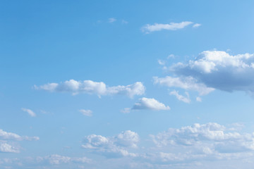 Blue sky with tiny and fluffy clouds.
