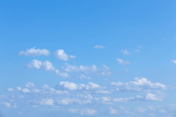 Naklejka na ściany i meble Blue sky landscape with tiny clouds.