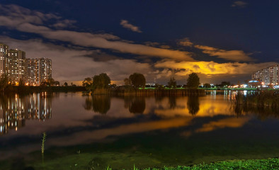 Night city landscape - view of the islands with trees and greenery in the city leisure park