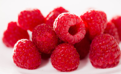 handful of raspberry berries on white background