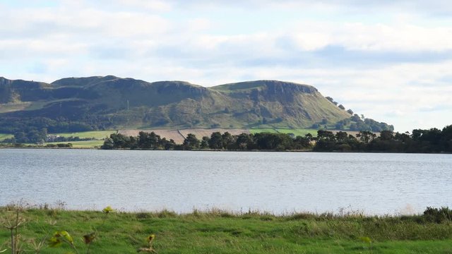 4K Video view of lake Loch Leven. Loch Leven is located immediately to the east of Kinross in Perth and Kinross council area, central Scotland. Sunny day in autumn in Scotland. Full HD stock video.