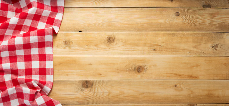 cloth napkin at rustic wooden background, top view