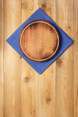 pizza cutting board and naplin at wooden background
