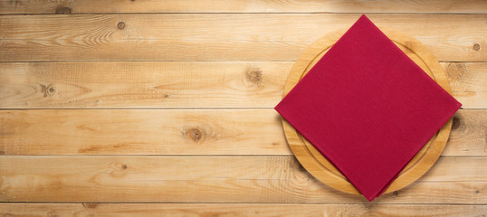 pizza cutting board and naplin at wooden background