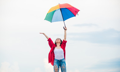 Rainy weather. Good mood. Good vibes. Open minded person. Girl feeling good sky background. Easy and free. Good weather. Welcoming fall. Pretty woman with colorful umbrella. Rainbow umbrella