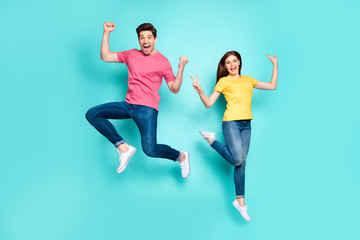 Full length body size view of nice attractive funky cheerful cheery crazy couple jumping in air...