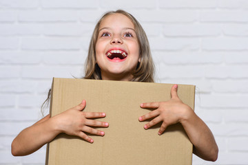 How home should feel. happy childhood. small girl child. little girl with box. moving to new apartment. perfect purchase. moving concept. move to new house. rent concept. repair annd relocate