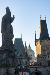 Fototapeta premium Statue and castles at old district of Prague view from Charles bridge. Czech republic symbol.