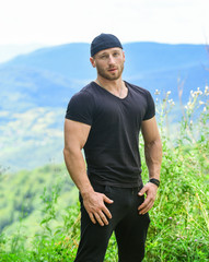 Fototapeta premium Masculinity and male energy. Man muscular bodybuilder mountain landscape background. Natural power. Masculine power. Tourist walking mountain hill. Hiking concept. Power of nature. Discover world