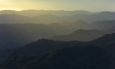 A view of diffused sun rays hitting a range of hills from the village of Hmuifang in Mizoram