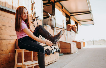 Woman putting on boots with gaiters