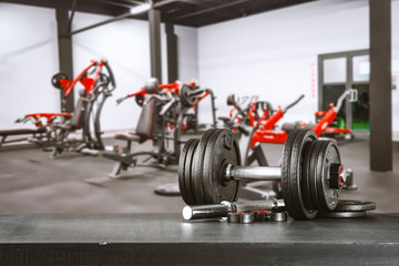 Obraz premium Gym interior and dumbbells on board with free space for your decoration. 