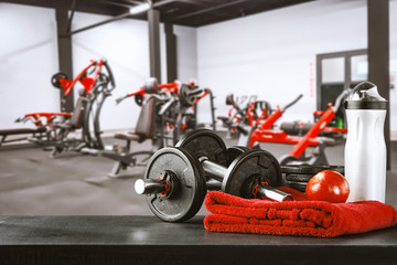 Gym interior and dumbbells on board with free space for your decoration. 