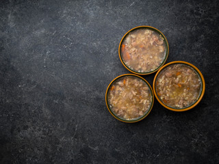aspic meat jelle in bowls over concrete background