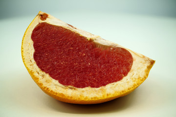 Grapefruit with grapefruit slice isolated on white background close up.