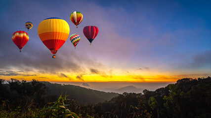 Colorful hot air balloons flying over Doi Inthanon National Park in sunrise time, Chiang Mai Province, Thailand.