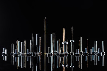 various shiny metallic screws isolated on black with copy space