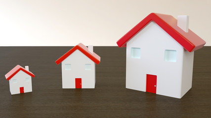 Three miniature houses with red roof on wooden, with blurred background. Image for property real estate, mortgage, insurance and home loan concept.