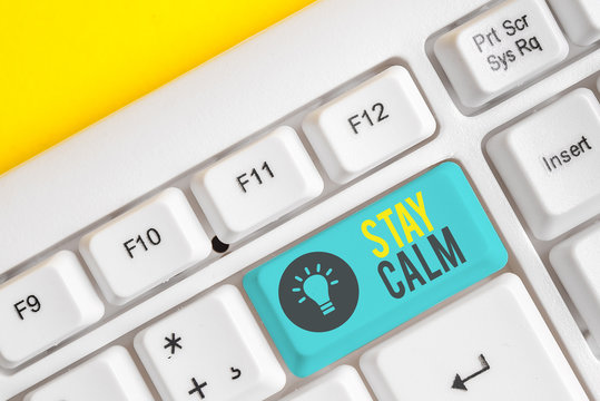 Conceptual hand writing showing Stay Calm. Concept meaning Maintain in a state of motion smoothly even under pressure White pc keyboard with note paper above the white background