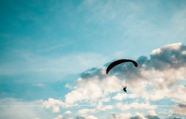silhouette of skydiver with parachute - live your dream, freedom and adrenaline concept