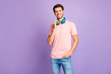 Portrait of his he nice attractive lovely cheerful cheery guy wearing pink tshirt bluetooth...