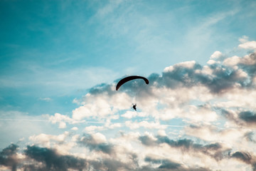 silhouette of skydiver with parachute - live your dream, freedom and adrenaline concept