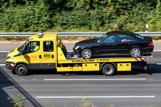 COLOGNE, GERMANY - JULY 13, 2018: ADAC flatbed recovery vehicle on motorway. German ADAC it is the largest automobile club in Europe.