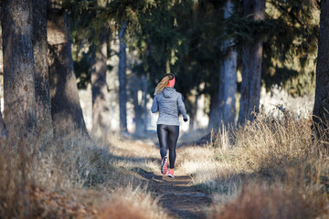 Young fitness woman running in the park