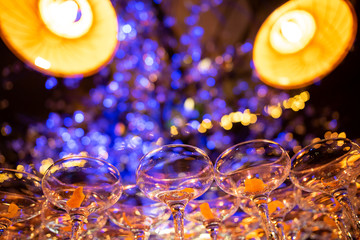 Empty cocktail glasses at a corporate event venue table with party lights 