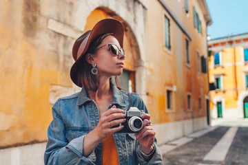Foto op Plexiglas Attractive tourist with a retro camera © AboutLife