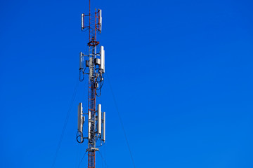 Telecommunication telephone signal transmission tower with beautiful blue sky background