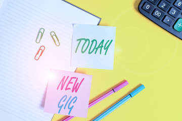 Text sign showing New Gig. Business photo showcasing getting job Attending live Concert Gigabyte Freelancer offer Empty blue paper with copy space paper clips and pencils on the yellow table