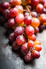 Ripe red grape on the rustic background. Selective focus. Shallow depth of field.