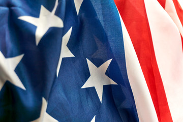 Detail of the American flag in red, white and blue with stars and stripes. National flag of the United States of America and symbol of patriotism, independence and freedom.