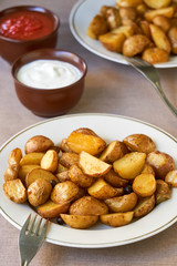 Baked potato wedges on a white plate