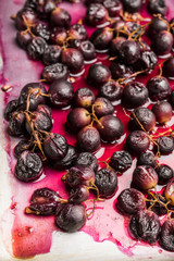 Roasted black grape on the rustic background. Selective focus. Shallow depth of field.